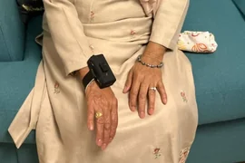 CareTether worn on a seated user-testing participant's wrist.