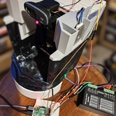 The assembled turret with its camera, motor mounts, wiring and Raspberry Pi at the base.
