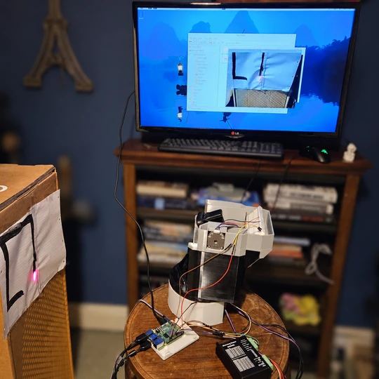 Monitor displaying the camera feed beside the assembled turret and marked tracking target.